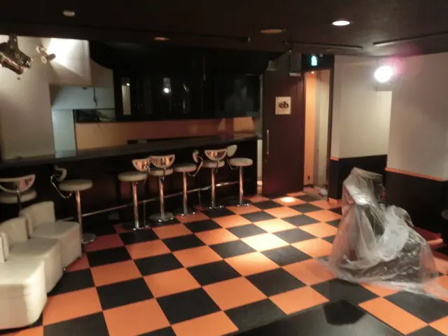 ライブハウスにオレンジの壁紙を貼った様子