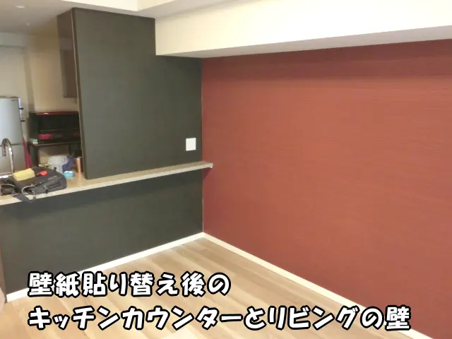 キッチンカウンターを黒い壁紙で貼り替え、リビングの壁を一面だけ赤い壁紙で貼り替えた部屋の様子。